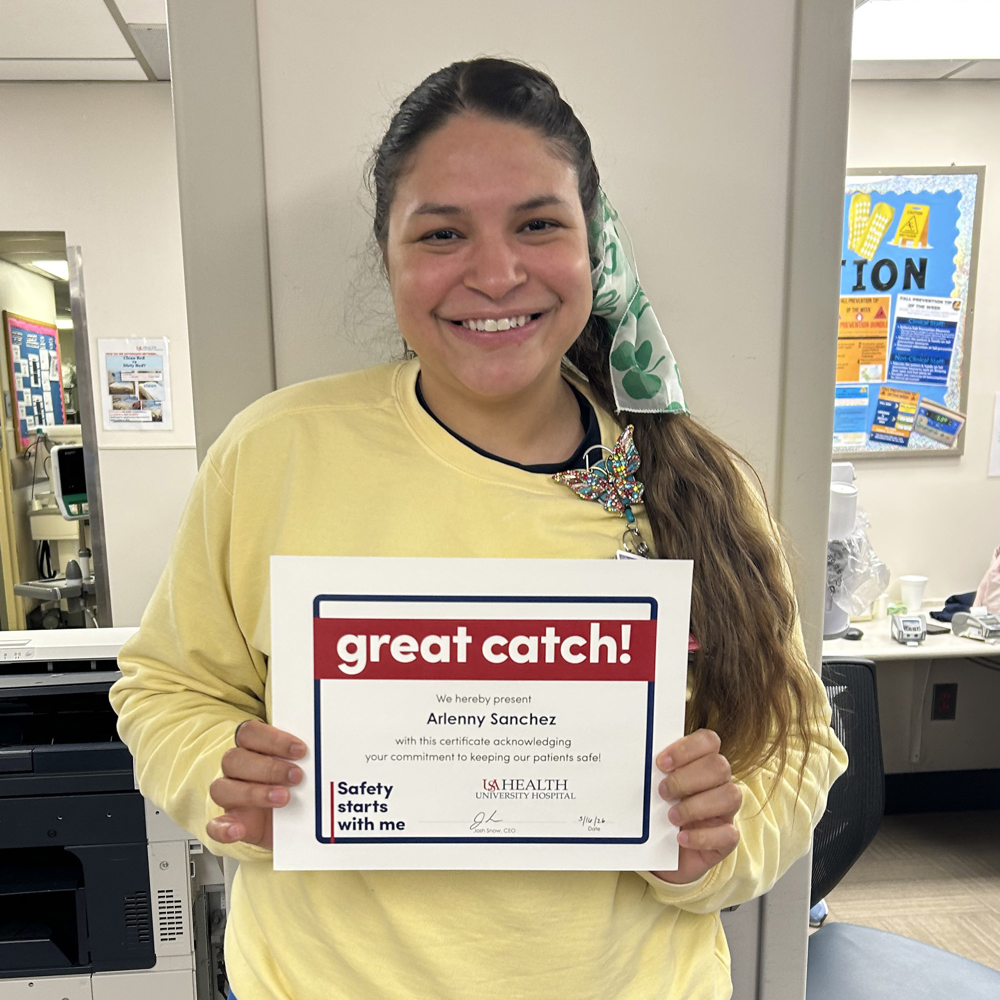 Arlenny Sanchez, RN, a nurse on the sixth floor, holds her Great Catch award.