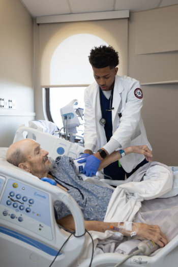 Jamael Nettles treats a patient at Providence Hospital.
