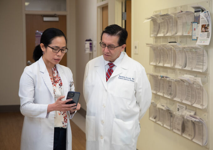 Benjamin Estrada consults with other provider in a clinic