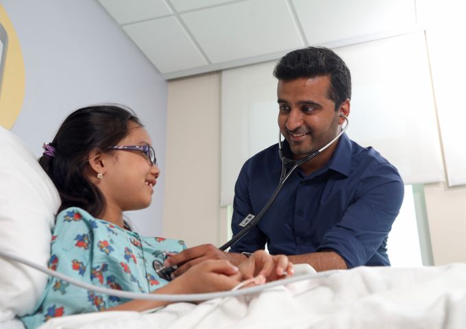 Mukul Sehgal, ﻿M.D., M.B.A., FAAP, checks on a pediatric patient.