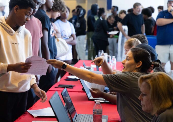 High school students line up for their sports physicals at a past USA Health event.