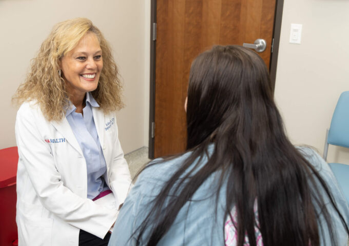Kelley Day, CRNP speaks with patient