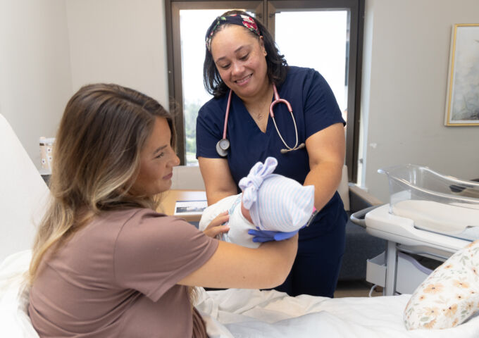 Children’s & Women’s Hospital - nurse handing baby to mother