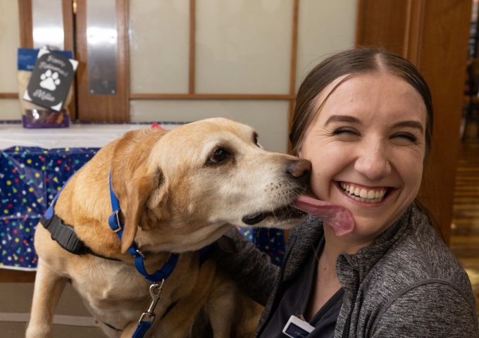 Amid wags and kisses, therapy dog Millie retires from service