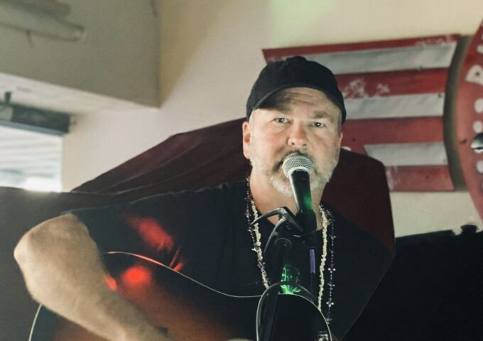 Rhett Plash performs with his guitar.