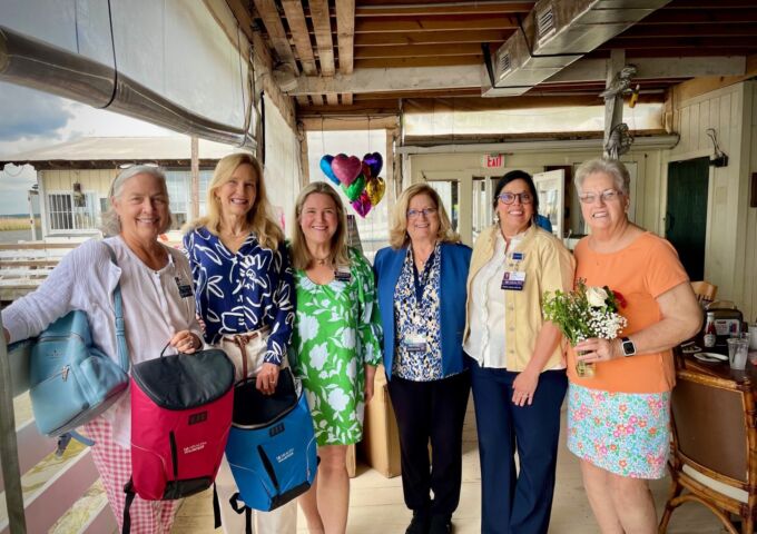 USA Health volunteers post with staff members at a celebratory event.