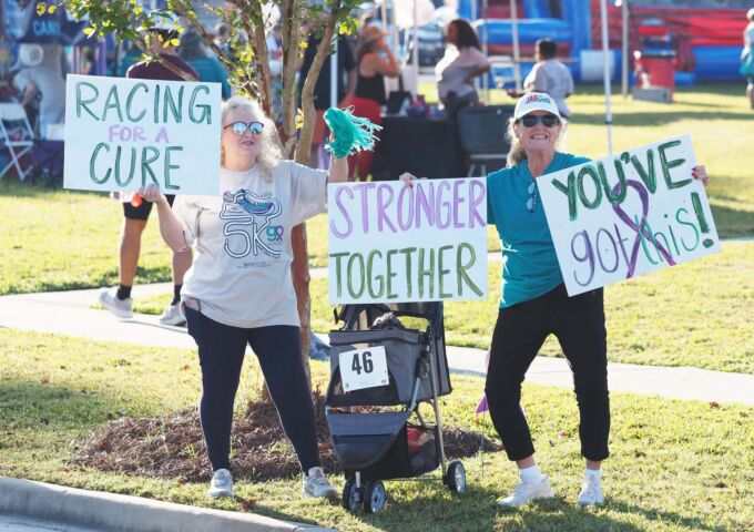 GO Run supporters with signs to encourage runners