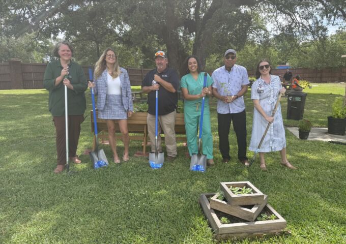 People standing amongst a community garden