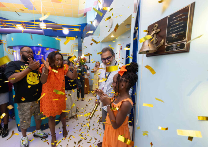 DeVyn Coker rang the bell inside the Hope infusion center to symbolize the completion of her treatment for cancer.