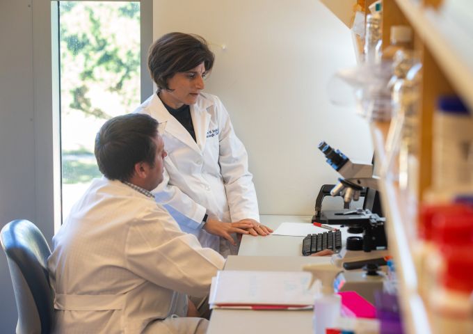 Researchers work at the USA Health Mitchell Cancer Institute.