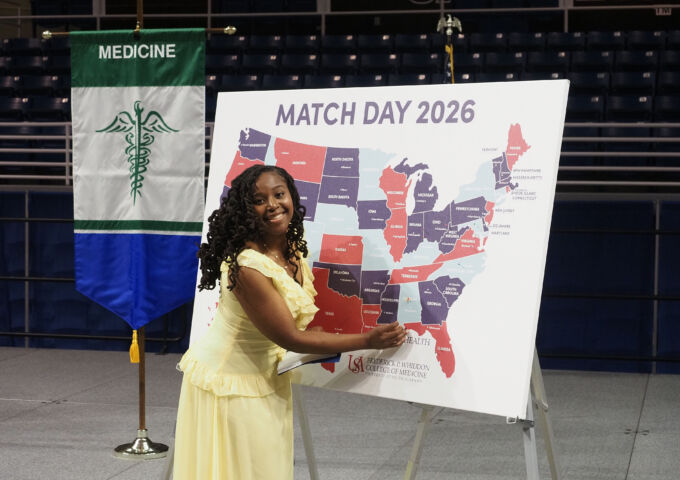 A medical student places a pin on a map to show the location of her upcoming residency.
