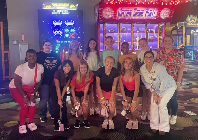 USA Health's teen volunteers pose for a photo while at an arcade.