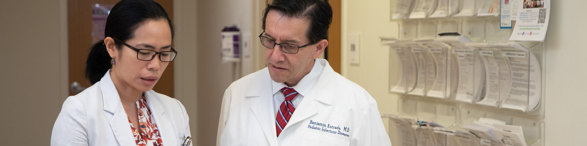 Benjamin Estrada consults with other provider in a clinic
