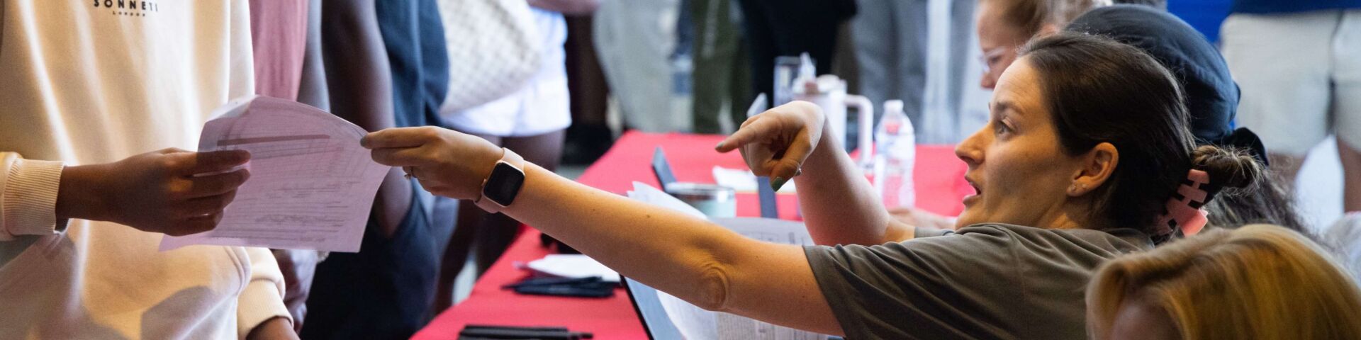 High school students line up for their sports physicals at a past USA Health event.