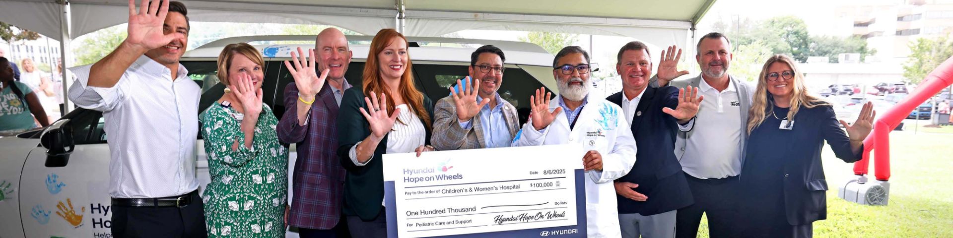 A giant check for $100,000 is presented by Hyundai Hope on Wheels.