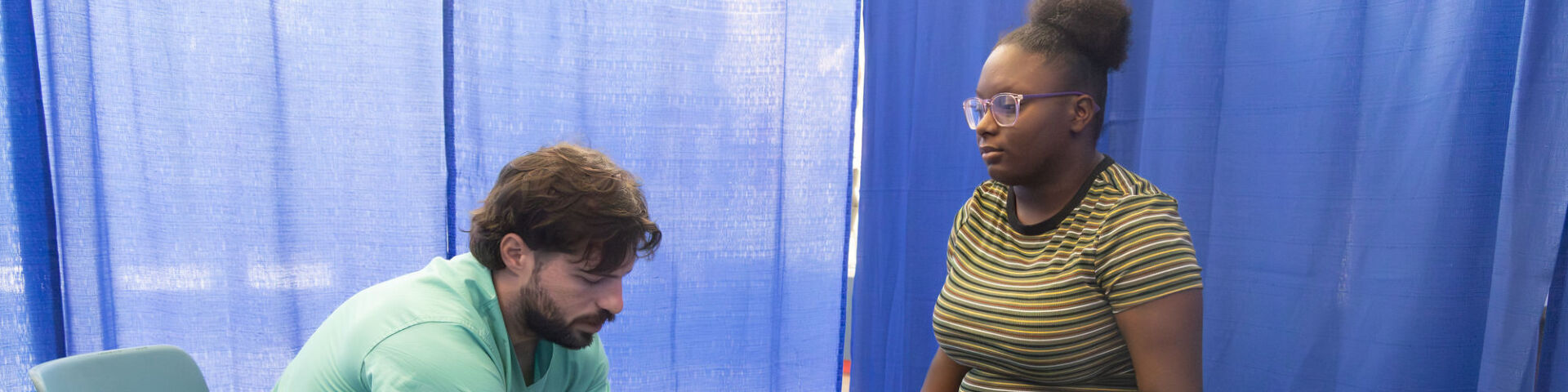 USA Health Orthopaedics and Sports Medicine fellow examines patient