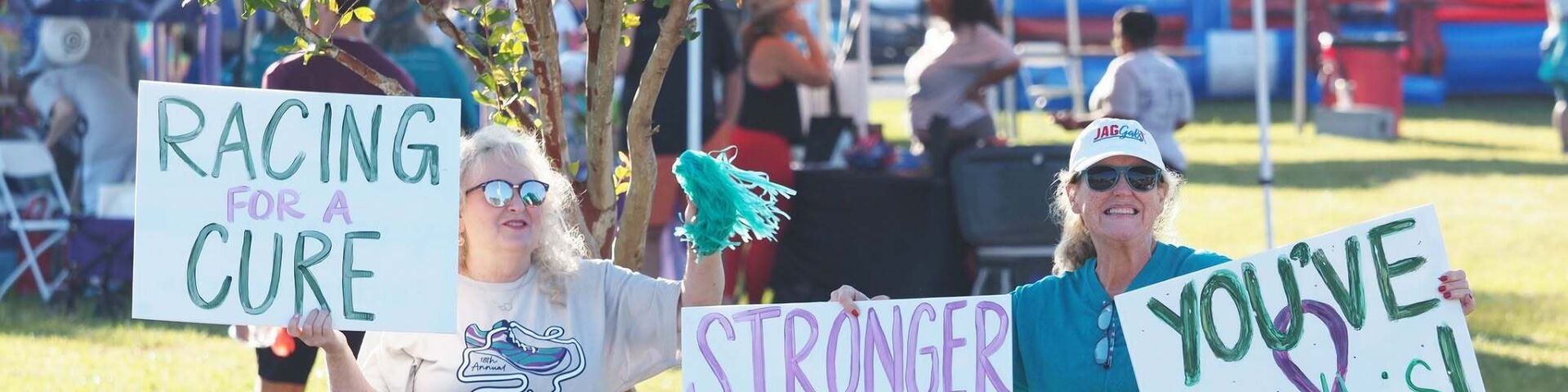 GO Run supporters with signs to encourage runners