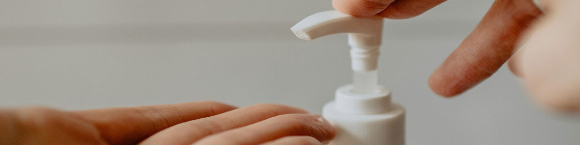 A person applies sanitizer to their hands.