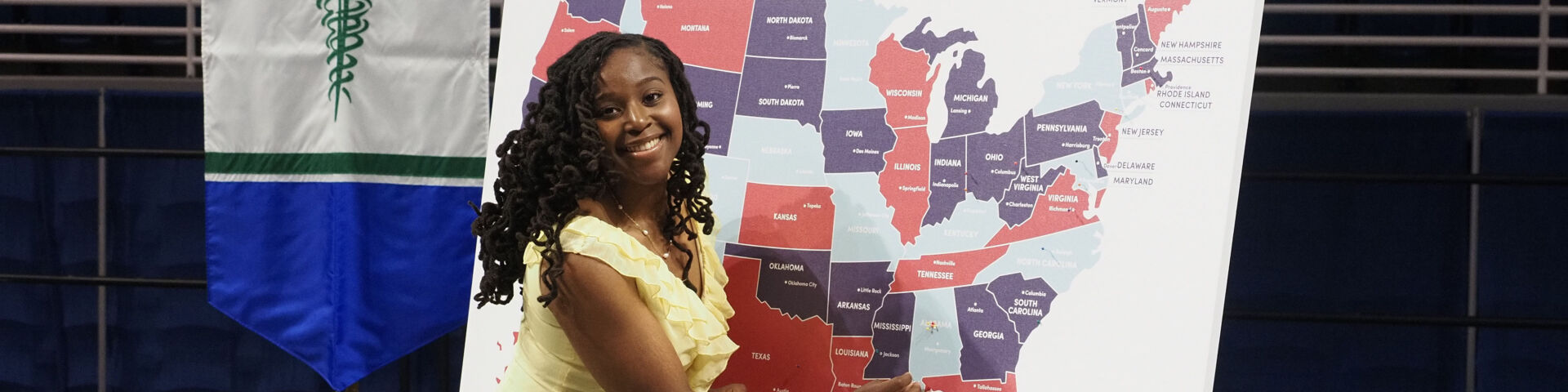 A medical student places a pin on a map to show the location of her upcoming residency.