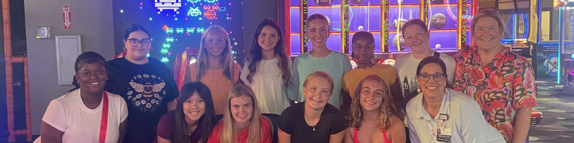 USA Health's teen volunteers pose for a photo while at an arcade.